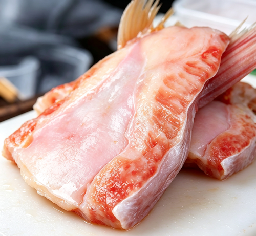 Fresh red snapper fillets, vibrant pink flesh and glossy surface